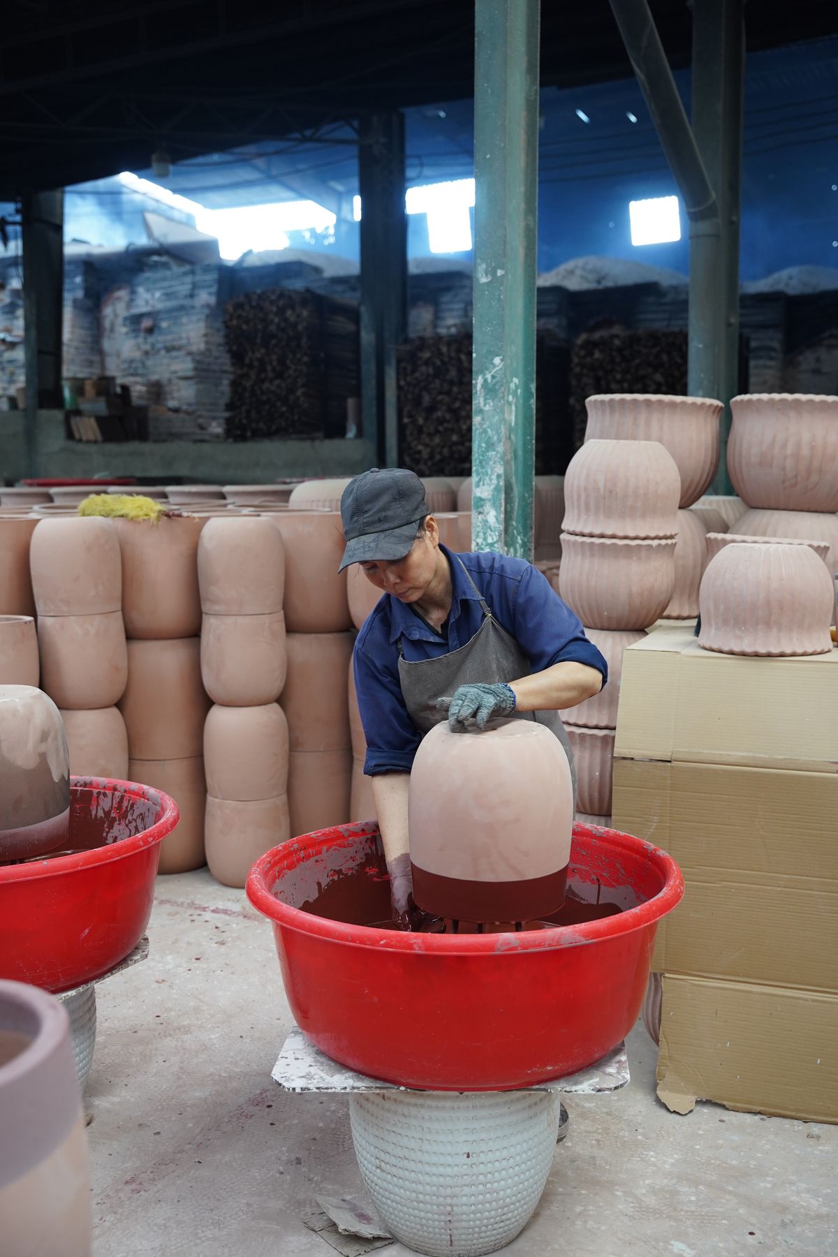 A pot glazed by hand before the dragon kiln, TNL & Son factory, Binh Duong, Vietnam