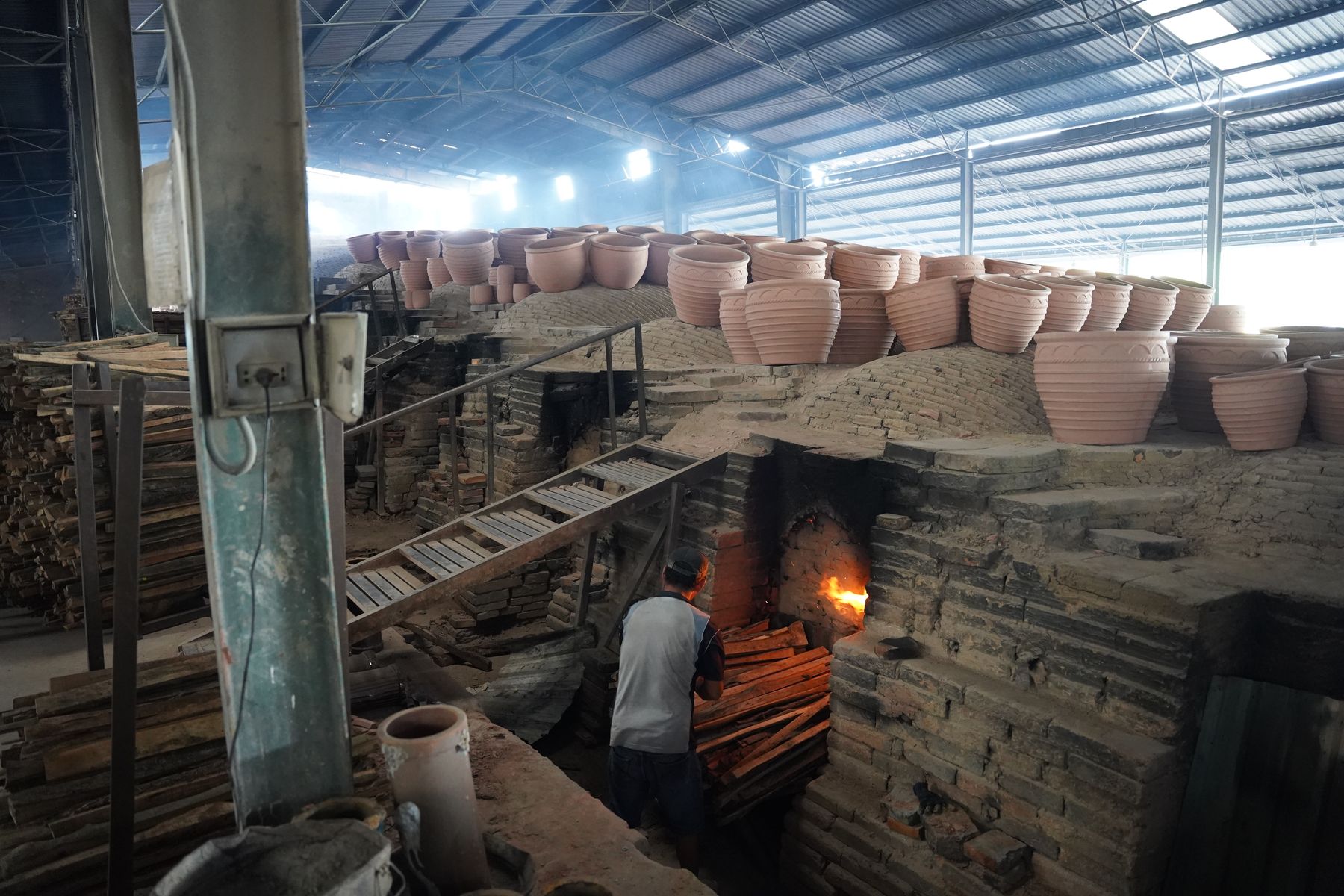Wood smoke over the dragon kiln during firing, TNL & Son factory, Binh Duong, Vietnam